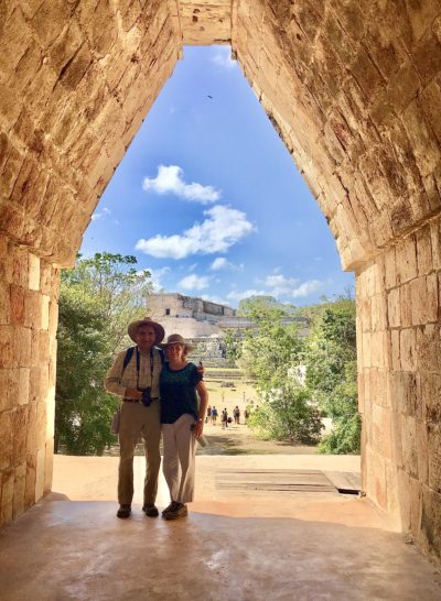 Traveler Jose Smith & wife Sandy stand in a stone archway at Uxmal in the Yucatan. 